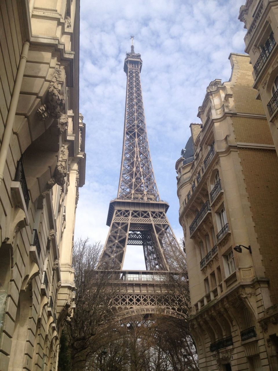 architecture, built structure, tower, building exterior, tall - high, eiffel tower, famous place, international landmark, low angle view, capital cities, travel destinations, tourism, city, culture, travel, sky, history, architectural feature, tall, skyscraper