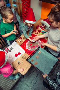 Woman preparing cookies with children at home