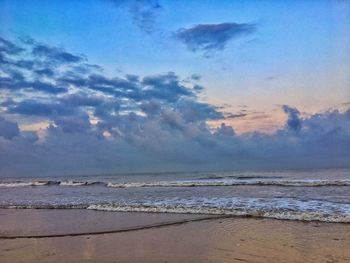 Scenic view of beach against sky during sunset