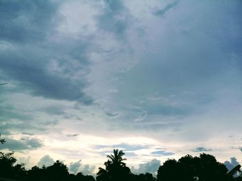 Low angle view of silhouette trees against sky at sunset