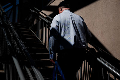 Rear view of man on staircase