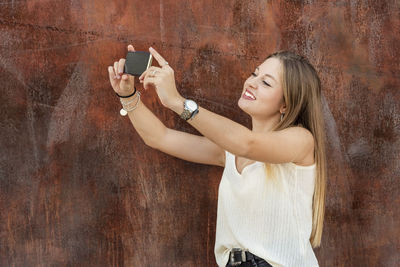 Woman photographing through smart phone