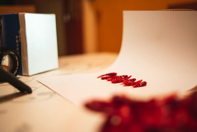 Close-up of red flowers on table