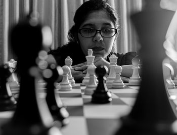 Close-up of woman playing chess
