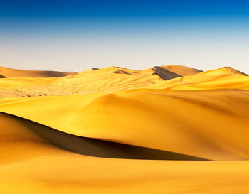 Scenic view of desert against clear sky