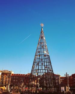 Low angle view of christmas decoration in city against clear sky