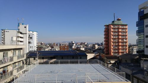 Buildings against clear blue sky