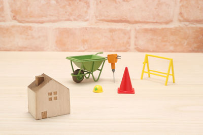 Close-up of toys against wall against building