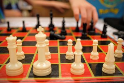 Close-up of hand playing chess on board