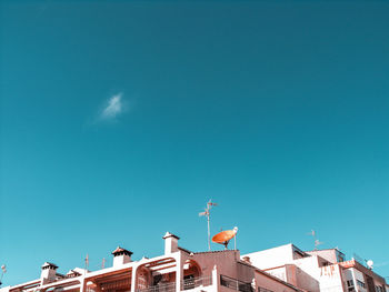 Low angle view of buildings against blue sky