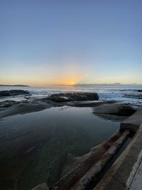 Scenic view of sea against clear sky during sunset