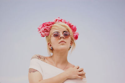 Close-up of young woman on gray background