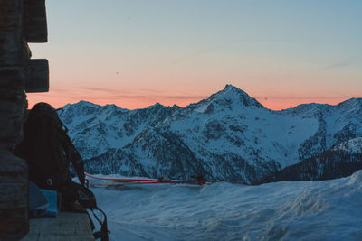 Scenic view of snowcapped mountains against sky during sunset