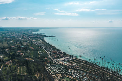 High angle view of townscape by sea against sky