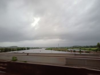 View of highway against cloudy sky