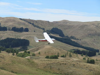 Airplane flying over landscape