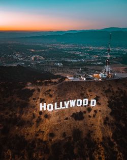 High angle view of hollywood sign on mountain during sunset