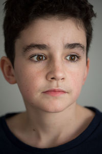 Close-up of teenage boy looking away