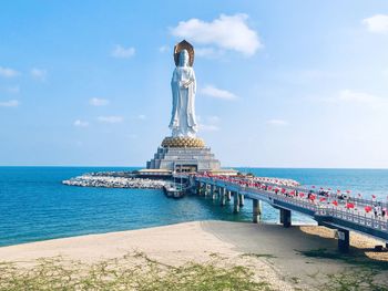 Statue of sea against cloudy sky