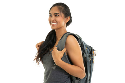 Portrait of smiling young woman against white background