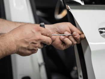 Close-up of man holding car