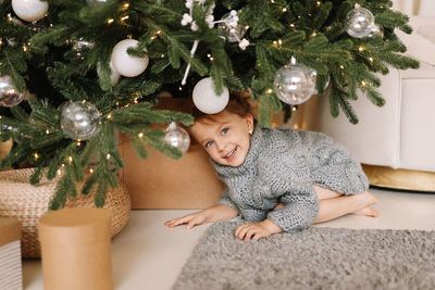 Portrait of boy playing with christmas tree