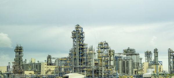 Petrochemical industrial plant with dark clouds