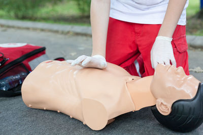 Low section of woman applying cpr on dummy