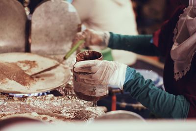 Midsection of man preparing food