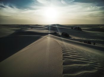 Scenic view of desert against sky during sunset