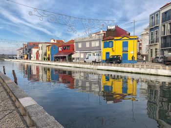 Canal amidst colorful buildings in city 