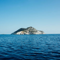 Scenic view of sea against clear blue sky