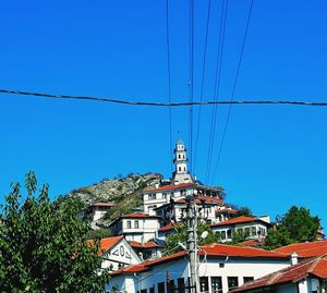 Low angle view of buildings against clear blue sky