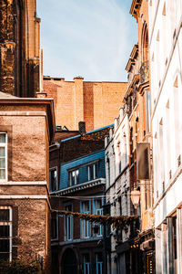 Low angle view of buildings in city against sky