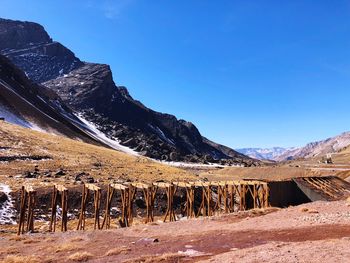 Scenic view of snowcapped mountains against blue sky