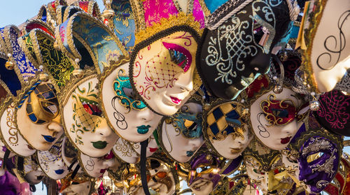 Close-up of various venetian masks for sale in market