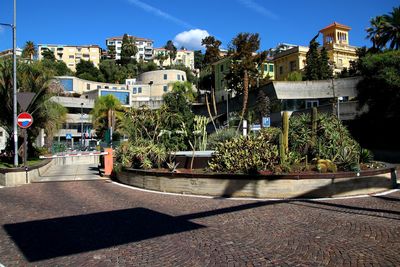 Street by swimming pool against buildings in city