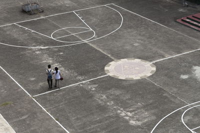 High angle view of man and woman in basketball court