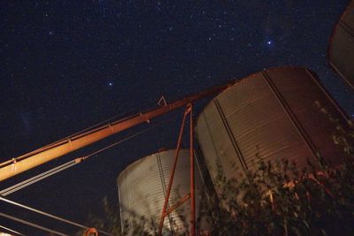 Low angle view of light trails in sky at night