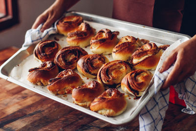 Midsection of man making cookies in baking sheet at home