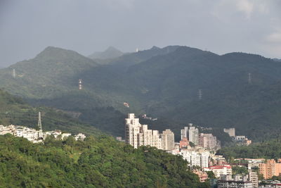 High angle view of buildings and mountains against sky