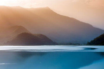 Scenic view of lake and mountains against sky