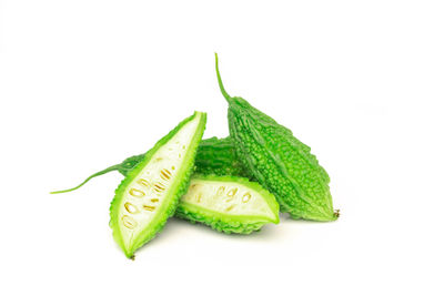 Close-up of green chili pepper over white background