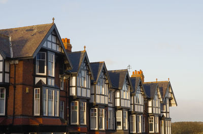 A row of large edwardian style house rooftops in early morning sun at scarborough