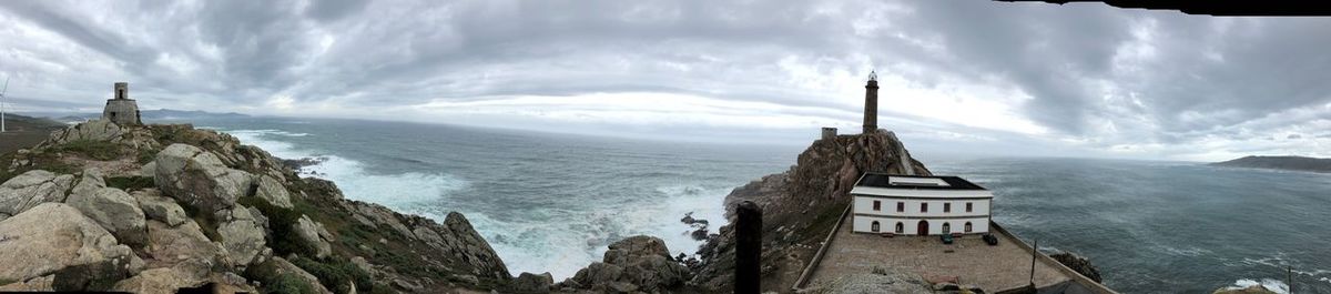 Panoramic view of sea and buildings against sky