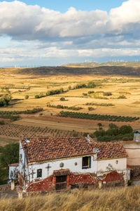 High angle view of houses on field against sky