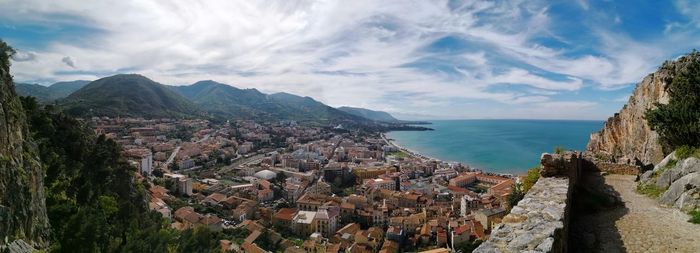 High angle view of sea and city against sky