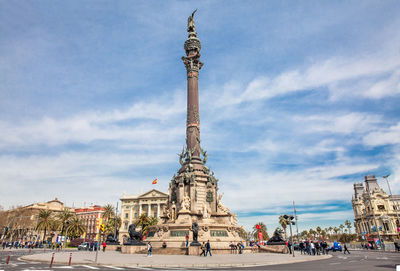 Statue of historic building against cloudy sky