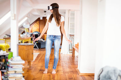 Full length of woman standing on floor at home