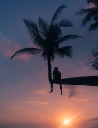 Low angle view of silhouette man against sky at sunset